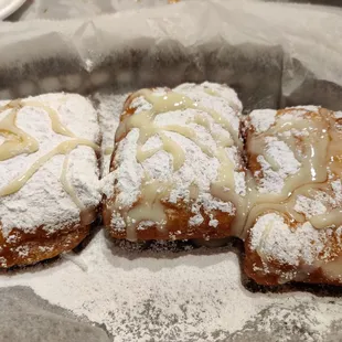 Beignets, dressed with condensed milk and honey.