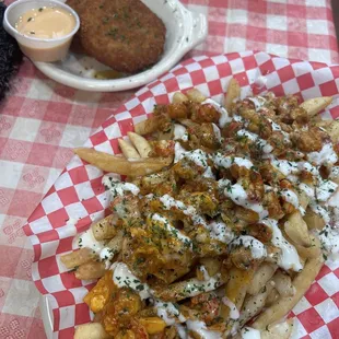 a plate of fries and a side dish