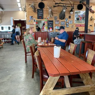 a man and a woman sitting at a picnic table