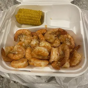 a container of shrimp and corn