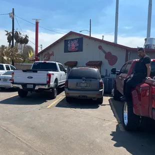 a man sitting on the back of a pickup truck