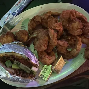 Fried buffalo shrimp, baked potatoes, and not pictured salad with ranch dressing