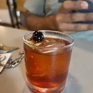 a drink in a glass with a garnish