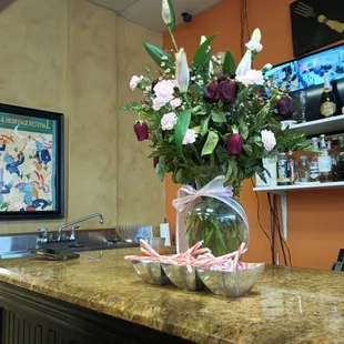 a vase of flowers on a counter