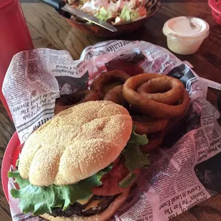 Double cheeseburger with onion rings and grilled chicken salad