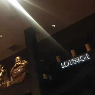 a lounge sign and statues