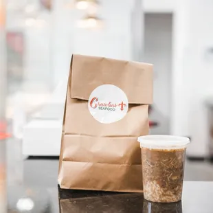 a paper bag and a cup of coffee