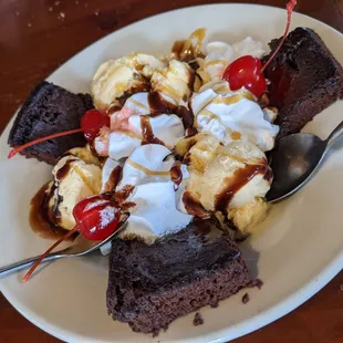 a chocolate sundae with ice cream and cherries