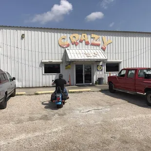 a man on a scooter in front of a building