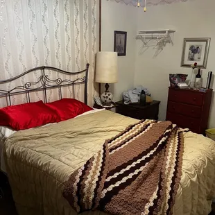 Double bed with old bedding.