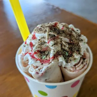rolled ice cream, vanilla base with strawberries and banana and whipped cream