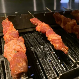 bacon being cooked on a grill