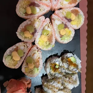 a plate of sushi and rolls