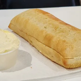 Hoagie size loaf of bread with very fluffy whipped butter.