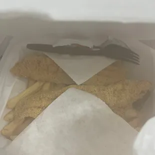 fish and chips in a paper bag