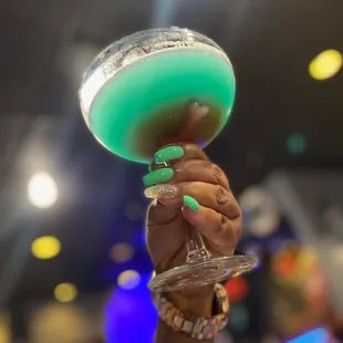 a hand holding a wine glass