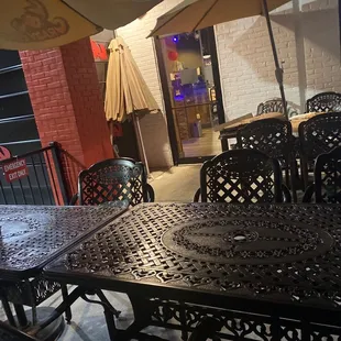 an outdoor dining area with tables and umbrellas