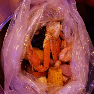 crab legs and corn in a plastic bag