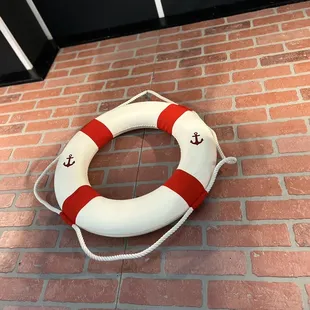 a life preserver on a brick wall
