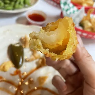  hand holding a piece of food