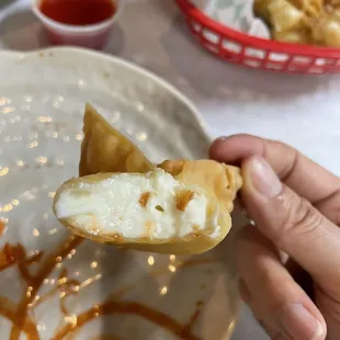  hand holding a piece of food