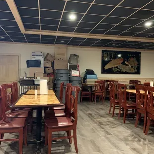 the inside of a restaurant with tables and chairs