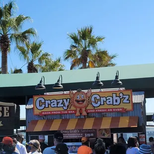 a crowd of people at a food stand