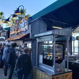 a line of people at a food stand
