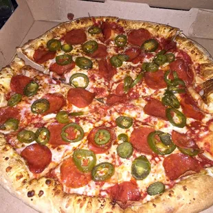 Large pepperoni and jalapeño pizza.