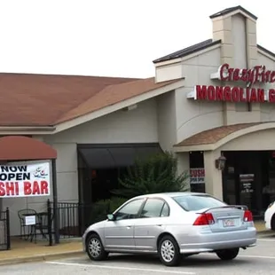 two cars parked in front of the restaurant