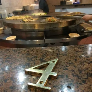 While waiting for your food, you get a number that correlates to your place on the stove and you watch your food get cooked.