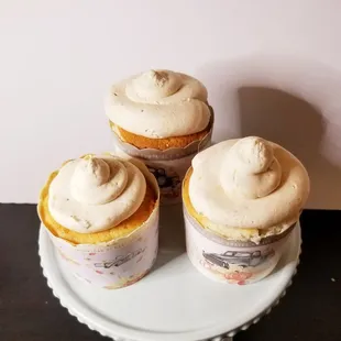 three cupcakes on a cake stand