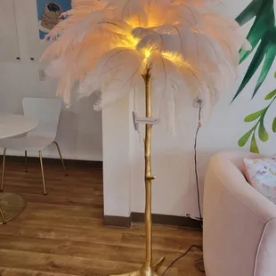 a floor lamp with feathers on it