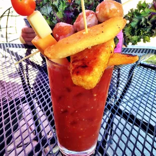 Seahawks-themed Bloody Mary. Vegan fish with fries, donut holes, cheese and tomato skewer, and kale.