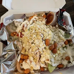 Dorilokos! Doritos, nacho cheese, crema, queso fresco, cueritos, avocado, corn, pico de Gallo, and cacahuate japones