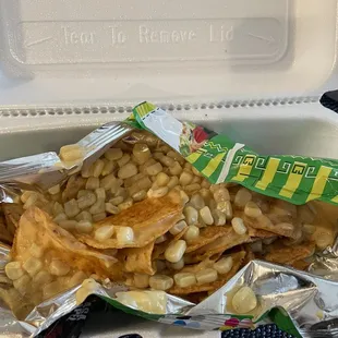Salsa verde Tostitos with nacho cheese and corn.