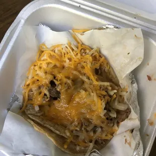 Asada taco (refried beans, meat, onion, loaded with cheese)