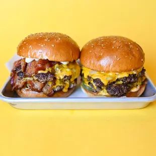 two burgers on a tray