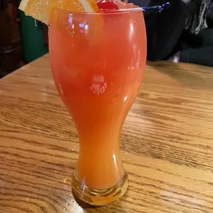 a glass of orange juice on a table