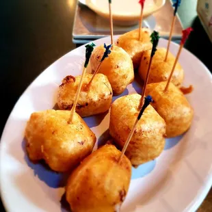 a plate of appetizers with toothpicks