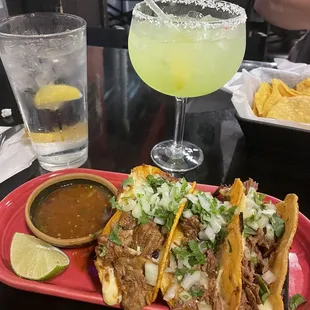 Lime margarita on the rocks with the birria tacos (consume on the side but not pictured)
