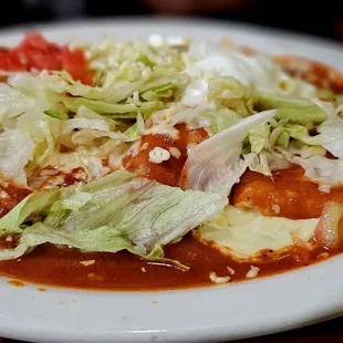 Enchiladas supreme.. 4 enchiladas (beef, chicken, beans, cheese) topped with cheese, lettuce and sour cream