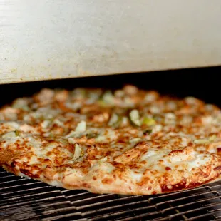a pizza cooking in an oven