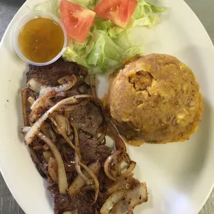 Mofongo with steak sautéed with onions. And more come visit us!! Good food, good price!!