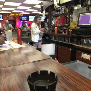 a woman standing at the bar