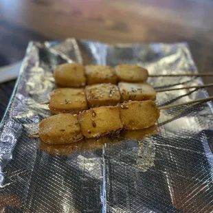 skewers of food on aluminum foil