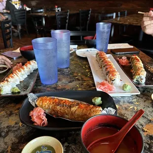 people eating sushi at a restaurant