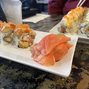 a plate of sushi and a plate of salmon