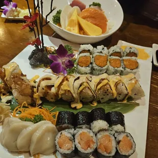 Smoked salmon roll, crazy roll, spicy tuna roll, fresh scallop sashimi and charashi bowl.