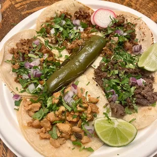 from top + left to right: two carnitas, asada, pollo, &amp; adobada